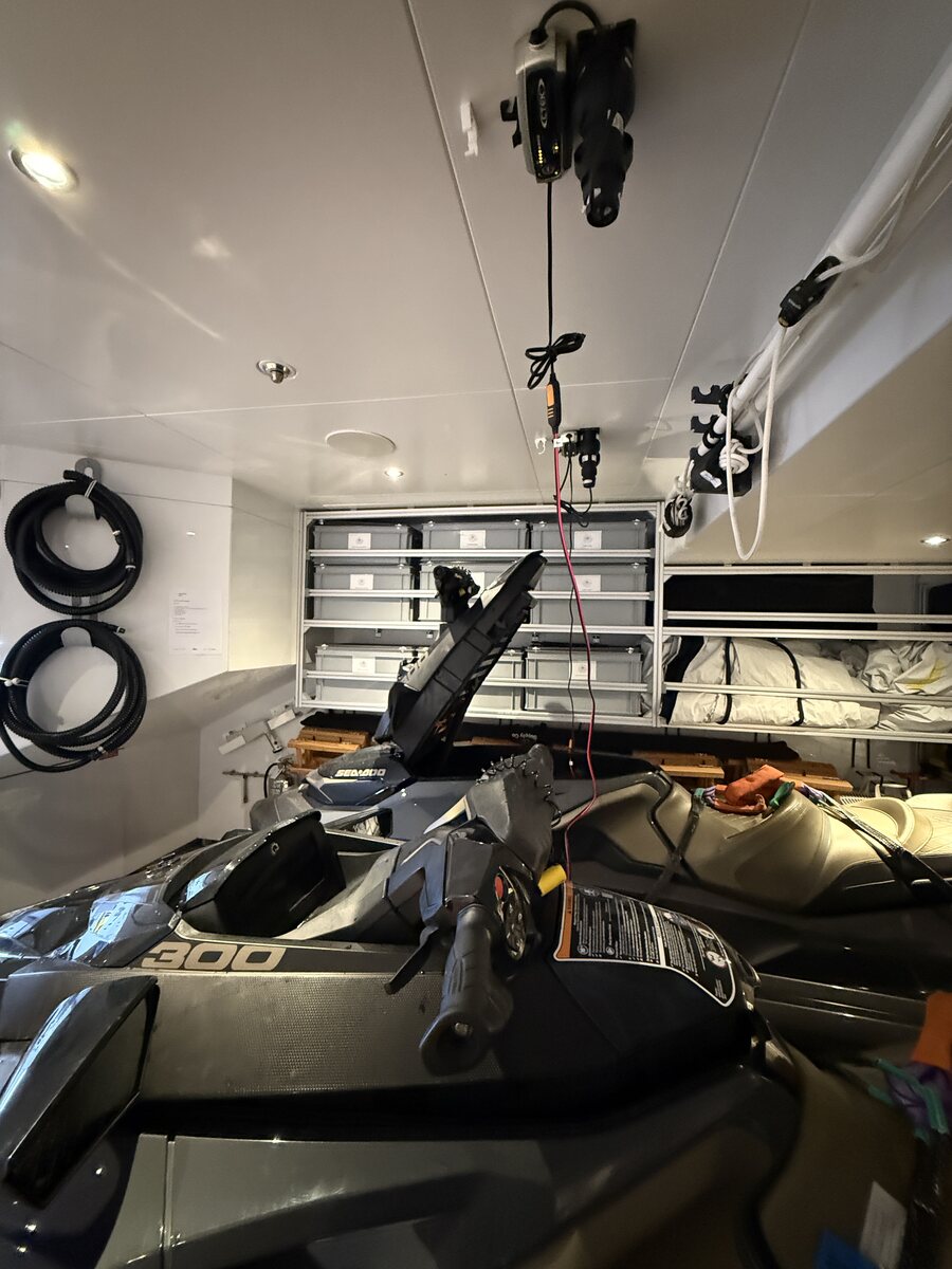 Sea-Doo jet skis on a yacht garage with overhead CTEK charging leads installed
