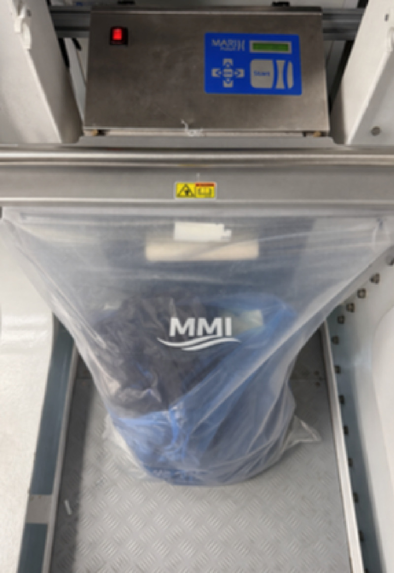 MMI-branded vacuum garbage bag sealed in a vacuum machine